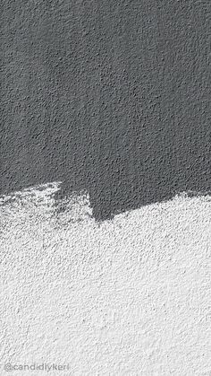 a black and white photo of a wall with paint chippings on it's side