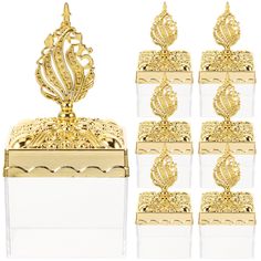 six pieces of gold colored jewelry sitting on top of a white box next to each other