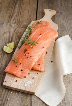 a piece of salmon on a wooden cutting board