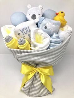 a baby boy gift basket with teddy bears and other items in it, on a white background