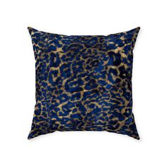 a blue and gold pillow with an animal print pattern on it's front side