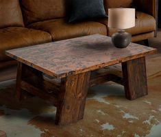 a wooden table sitting in front of a brown couch