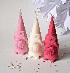 three small candles with pink and white frosting on them