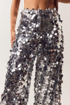 Sequins are always the right answer. Feel glam in our sequin pants, made in high quality sequin fabric, with a stellar wide leg fit, and a textured sequin design. Wear with the matching blazer for a stellar occasion look, perfect for bachelorette nights, engagement parties, and all of your upcoming events, or pair with jeans to dress it down. Disc Sequin Two Piece Wide Leg Pants High Quality Sequin Fabric Unique Large Sequin Design Fierce Wide Leg Silhouette Comforable High Waistline Matching Blazer Sold Separately Model wears a size M (US size 6/UK size 10). Sequin Wide Leg Pants, Sequin Two Piece, Black Friday Makeup, Sequin Jeans, Black Tie Party, Going Out Trousers, Large Sequins, Dress With Jean Jacket, Sequin Pants