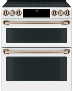 two white and gold ovens side by side