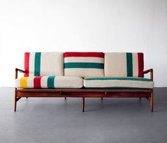 a striped couch sitting on top of a wooden frame