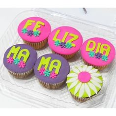 six decorated cupcakes in a plastic container with the letters ma and f on them