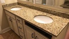 a bathroom with two sinks and a large mirror