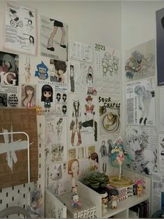 a room filled with lots of pictures and posters on the wall next to a desk