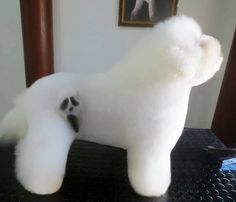 a white stuffed animal sitting on top of a table