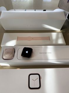 an apple watch sitting on top of a white box