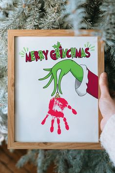 a handprinted christmas ornament hanging from a tree with the words merry grin's on it