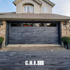 a house with a wooden garage door in front of it