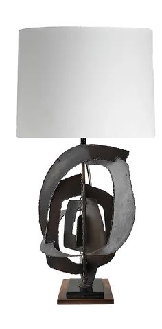 a table lamp with a white shade on it and a metal sculpture in the shape of a boat