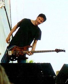 a man standing on top of a stage with a guitar in front of his face