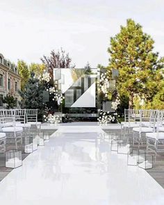 an outdoor ceremony setup with white chairs and flowers