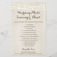 the wedding photo scavenger hunt is displayed on a white marble table with lights around it