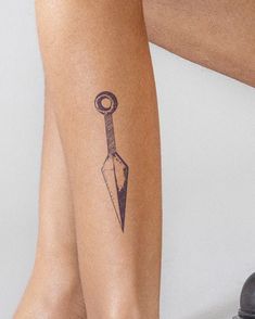 a person with a knife tattoo on their leg