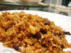 a white plate topped with rice and raisins