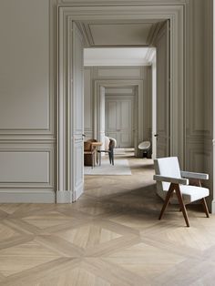 an empty hallway with white walls and chairs