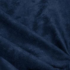 a close up view of a blue velvet fabric with very soft folds and textured edges