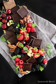 chocolate, berries and nuts arranged on top of each other