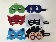 six masks with different colors and designs on them, each one has a cat's head