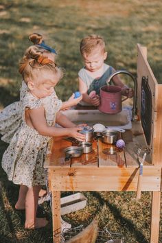 "Get ready for some messy and imaginative playtime with this wooden Mud Kitchen from GCR Wooden Creations! Crafted with care, this toy is perfect for children who love to pretend and create their own little adventures. The inclusion of a fully functional faucet enhances the play experience, allowing your little ones to engage in water activities as they concoct mud masterpieces.   Made with cedar wood and built to withstand outdoor play, this mud kitchen will provide endless hours of entertainment for your little one.  Encourage imaginative play, sensory exploration, and a love for the outdoors with our Mud Kitchen - where the joy of nature meets the creativity of childhood.   The mud kitchen is 35\" long x 35\" high x 20\" deep.  The playing surface is 20.5\" tall.  All appearance boards Montessori Outdoor Play, Mud Kitchen For Kids, Indoor Playground Design, Action Board, Wooden Creations, Kitchen Water, Sensory Exploration, Outdoor Play Areas, Sensory Activity