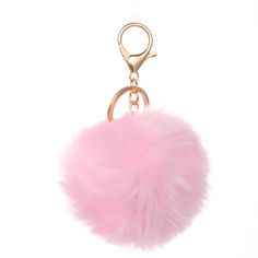 a pink pom - pom keychain on a white background