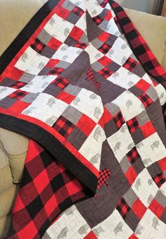 a red and black quilt on a couch