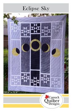 the eclipse sky quilt pattern is shown on display in front of a green yard with trees and