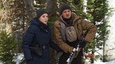 two people standing next to each other in the snow