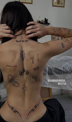 a woman with many tattoos on her back