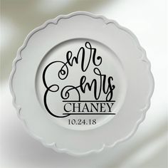 a white plate with the words mr and mrs on it in cursive font