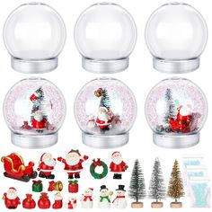 four snow globes with santa and other christmas decorations