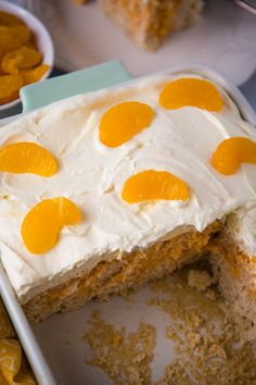 there is a cake with oranges on it in the pan and one slice has been taken out