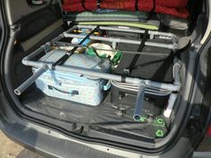 the back end of a car with luggage packed in it's trunk and seats