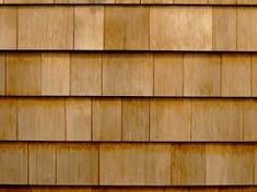 a close up view of the shingles on a wooden house's roof, which is made of wood planks