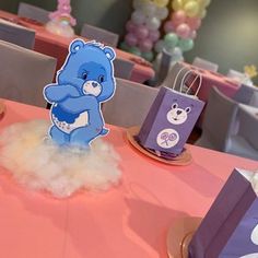 there is a blue bear on the table at this baby's first birthday party