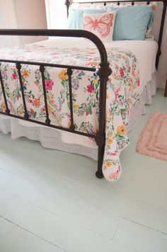 a bedroom with a bed and rugs on the floor