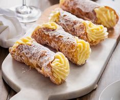 three pastries are sitting on a cutting board