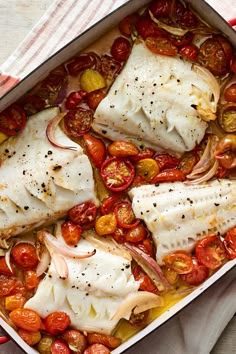 two fish fill the dish with tomatoes and onions