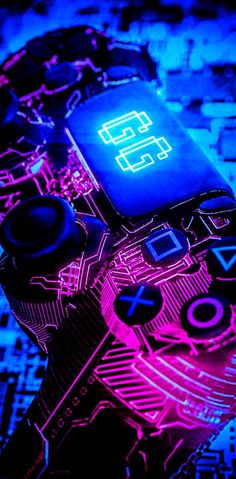 a close up of a game controller with neon lights