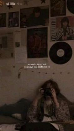 a person sitting on a bed with a camera in front of their face and the words, songs to listen to if you have this aesthetics - 4