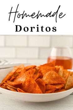 homemade tortilla chips in a white bowl next to a glass of honey syrup