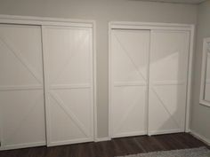 three white doors in a room with wood floors