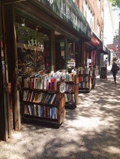 the sidewalk is lined with books on display