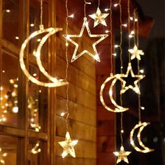 stars and crescents are hanging from the side of a building with lights on it