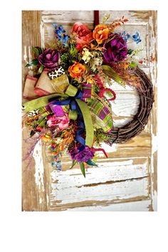 a wreath with flowers and ribbons hanging on the front door to decorate it for someone's special occasion