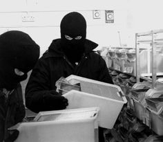 two people wearing masks are looking at boxes